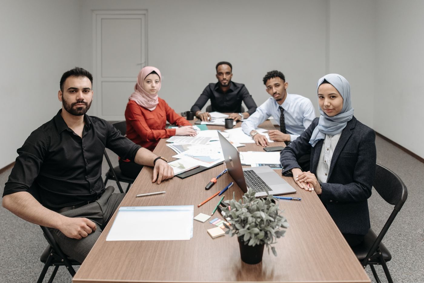 A diverse group of professionals seated around a table during a business meeting