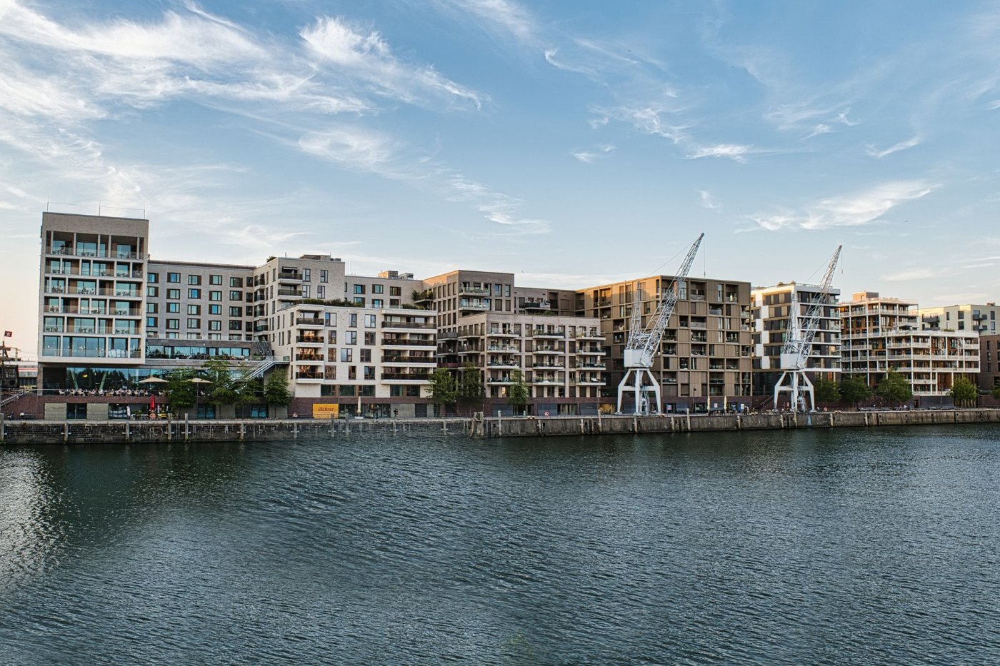 Modern apartment buildings under construction with cranes, representative of new mixed-use development